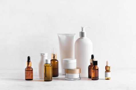 istockphoto-1354674340-612×612 Skincare Beauty Products on white table, assortment of cosmetics bottles, healthy cosmetology, spa treatment concept, copy space.
